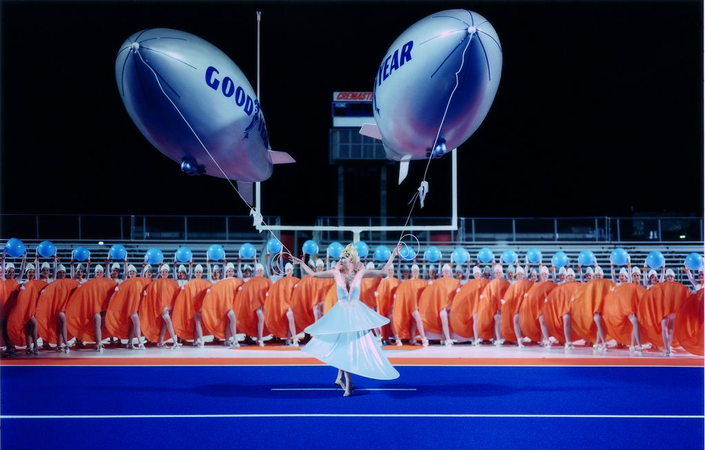 Frau in einem Stadion mit zwei Zeppelin Ballons in der Hand