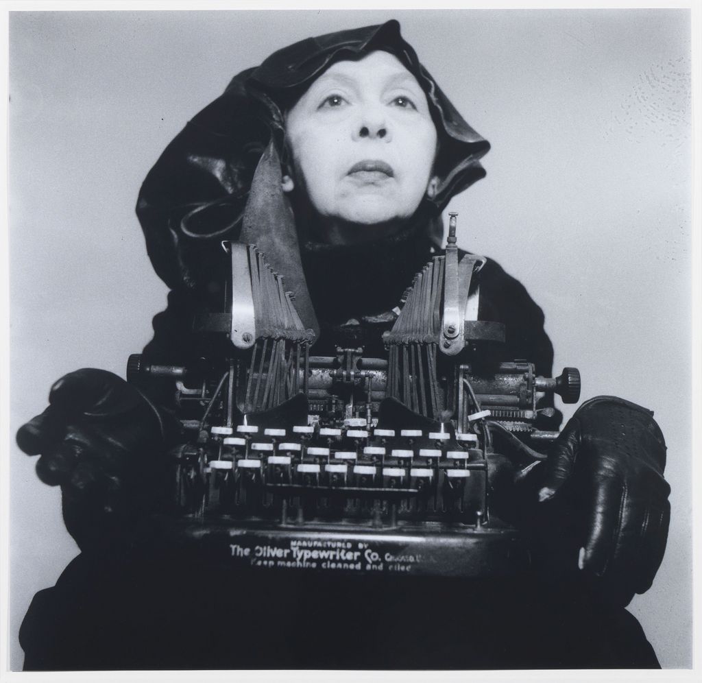 Woman holding a typewriter in her hands